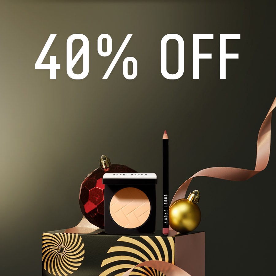 Close up of Long-Wear Cream Shadow Stick with swatch behind on top of a soft-grey background